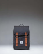 Herschel Retreat Mini Backpack in Black. Front view showcasing its classic design with a top handle, single strap closure, and front storage sleeve.