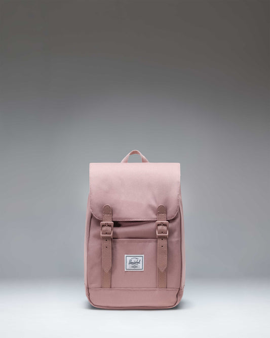 Herschel Retreat Mini Backpack in Ash Rose, a dusty pink color, featuring a drawstring closure and a single magnetic strap.