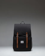 Herschel Retreat Small Backpack in black, showcasing its classic design with a single strap closure and a clean, compact silhouette.