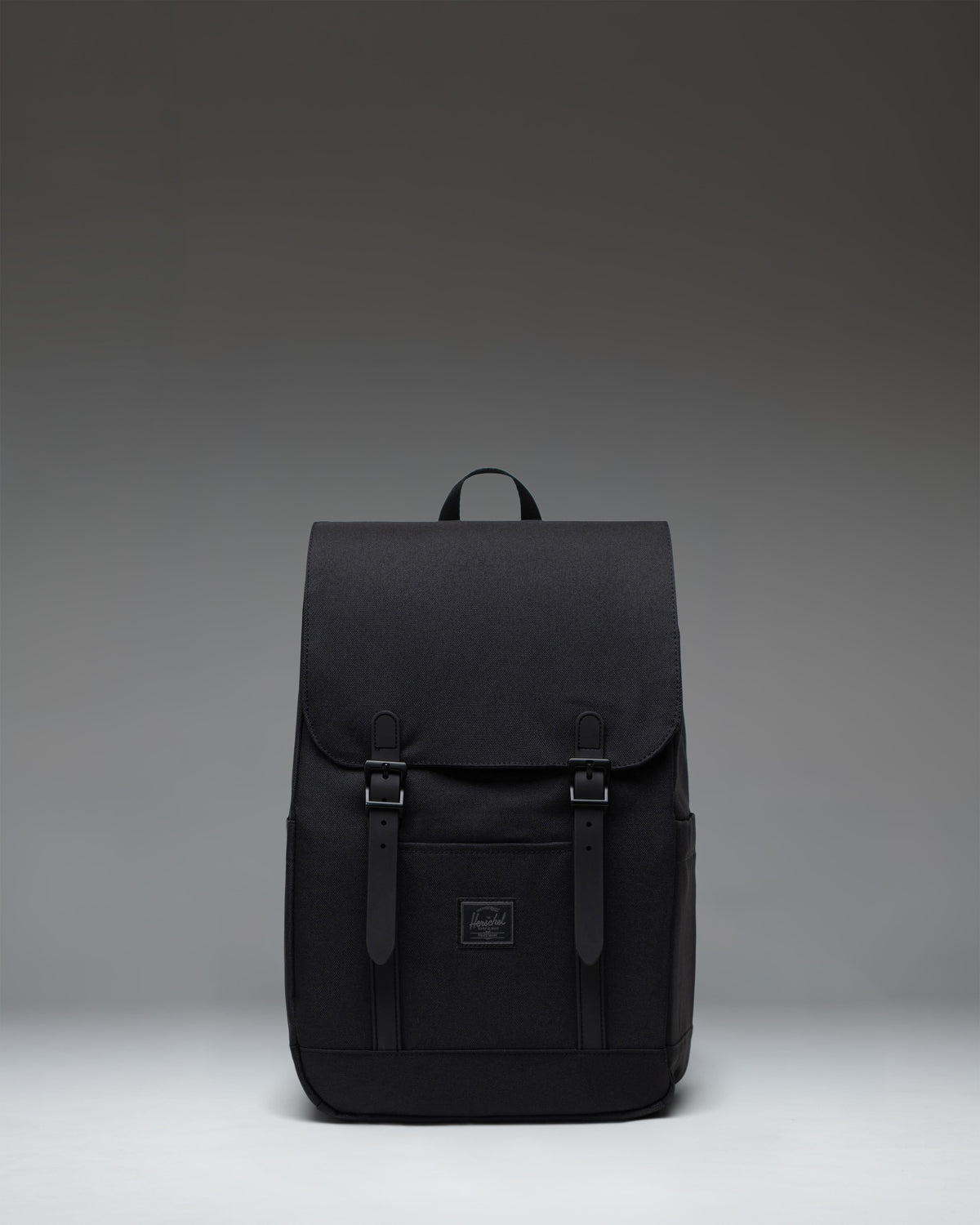 Herschel Retreat Small Backpack in Black Tonal, featuring a classic silhouette with front straps and a clean, minimalist design.
