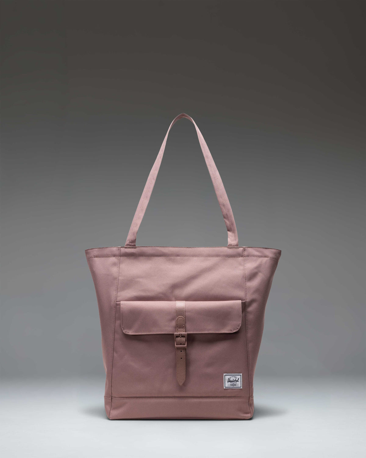 Herschel Retreat Tote bag in Ash Rose, showing a spacious main compartment, dual top handles, and a clean minimalist design.