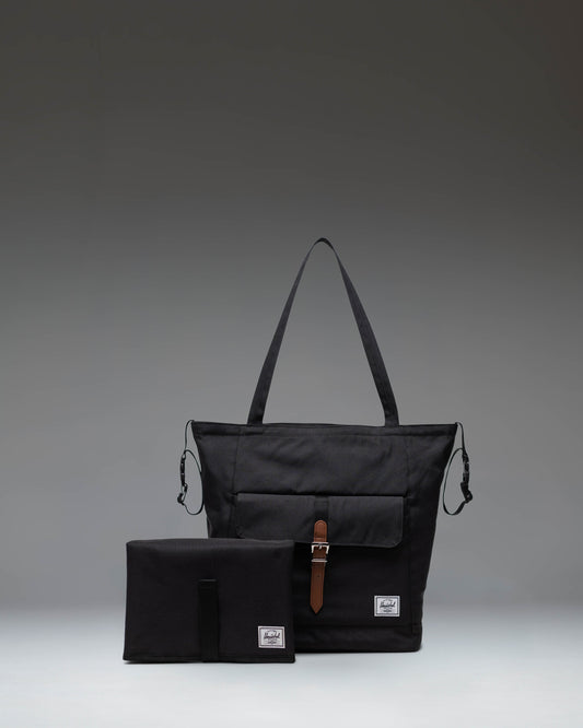 Black Herschel Retreat Tote Diaper Bag shown from the front, highlighting its clean design, shoulder straps, and iconic woven label.
