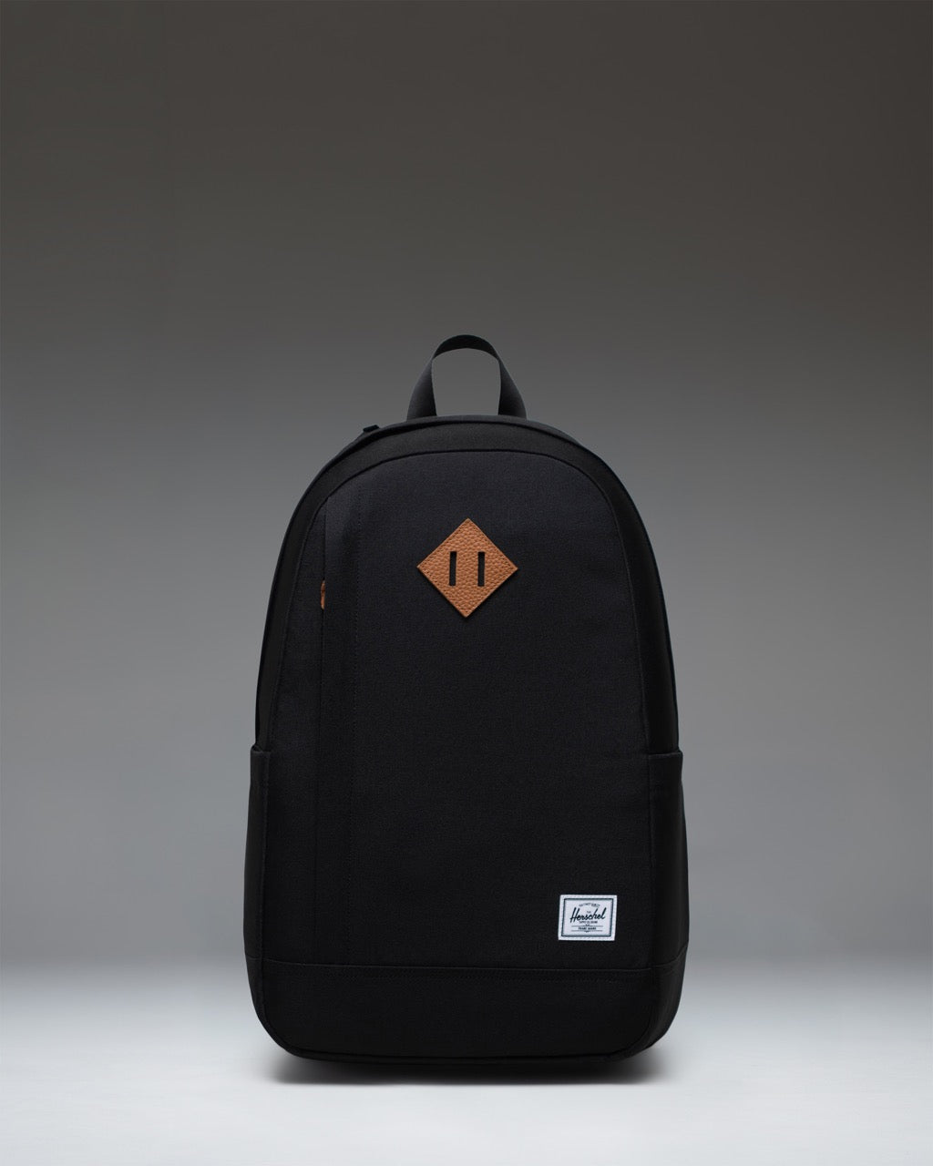 Herschel Supply Co Seymour Backpack in black, showing the front view with dual straps and zipper details.