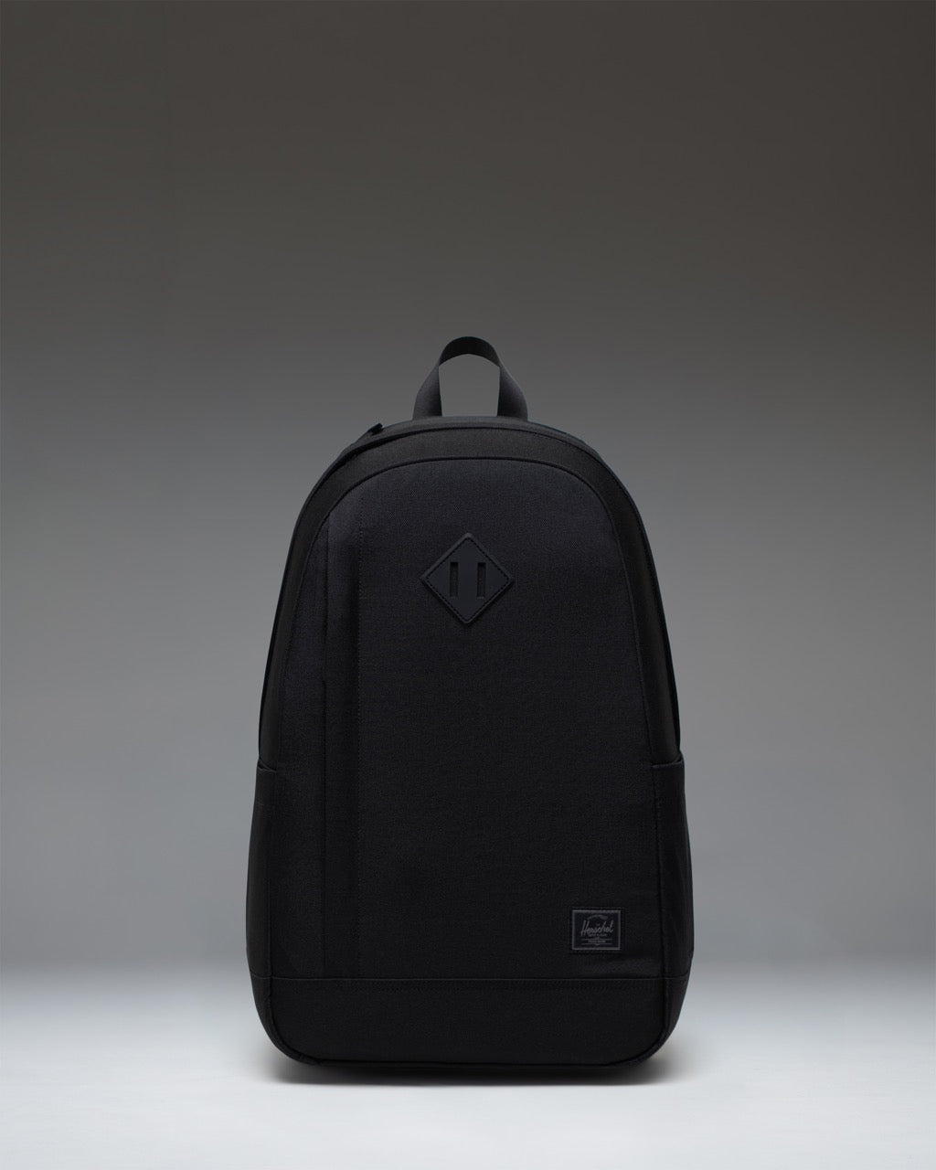 Herschel Seymour Backpack in Black Tonal, featuring a clean front view with zippered compartments and a tonal classic woven label.
