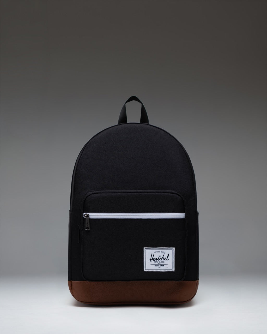 Herschel Supply Co. Pop Quiz Backpack in Black/Tan featuring a front pocket, leather accent, and signature woven label.