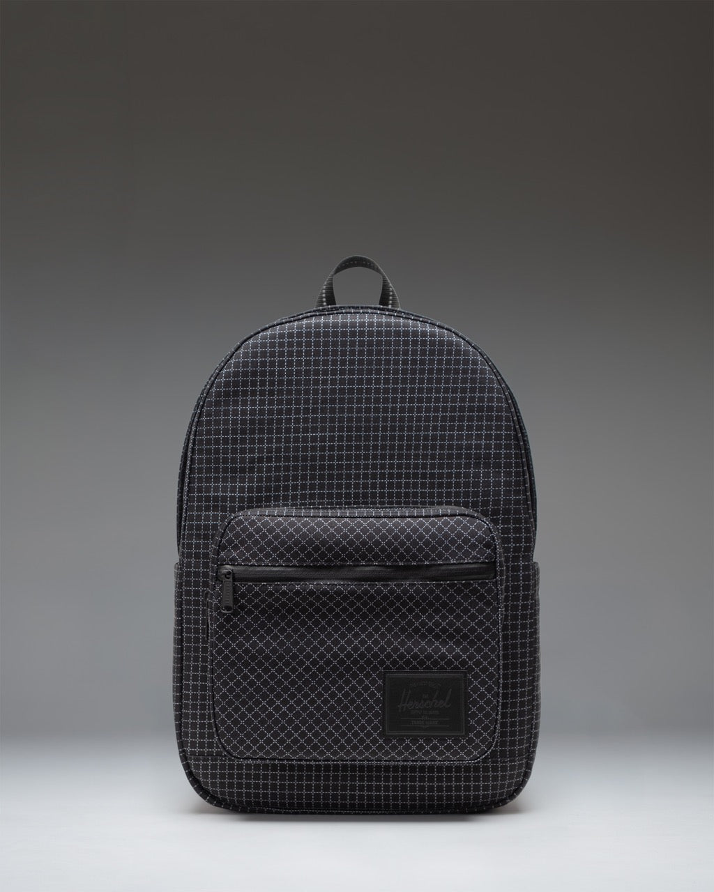 Herschel Supply Co. Pop Quiz Backpack in Grid - Black, showing a black checkered pattern with a front zipper pocket and the brand logo.