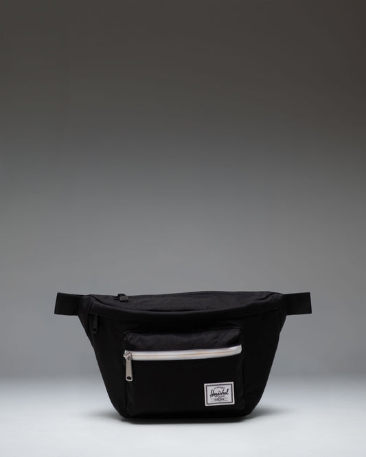 Black Herschel Supply Co Pop Quiz Hip Pack with a front zipper pocket, waterproof zipper detail, and an adjustable strap with a buckle.