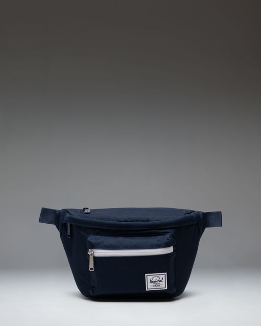 Herschel Supply Co. Pop Quiz Hip Pack in navy blue, showcasing its clean design, front pocket, and adjustable strap.