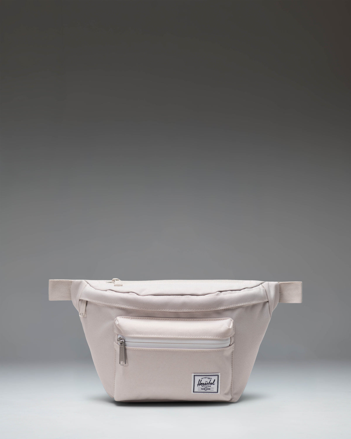 Herschel Supply Co. Pop Quiz Hip Pack in Moonbeam beige, featuring a front zipper pocket and adjustable strap.