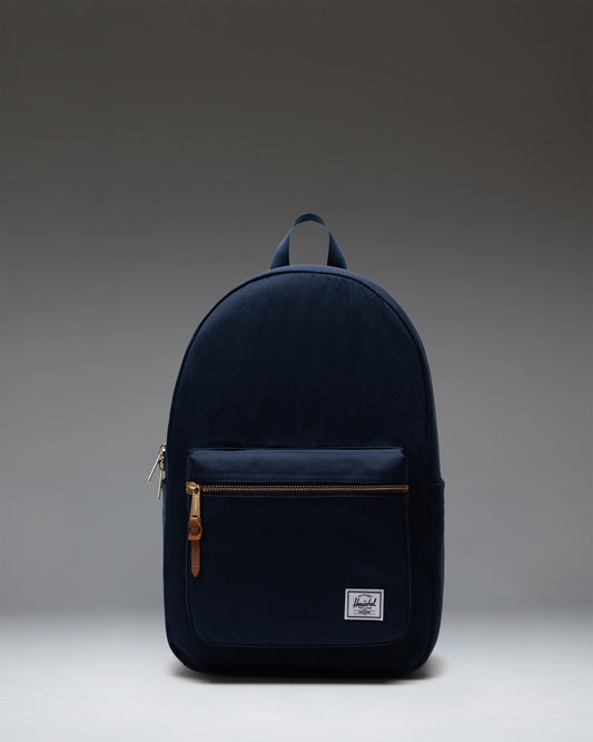 Herschel Supply Co. Settlement Backpack in navy blue, front view showing zippered pocket and classic woven label.