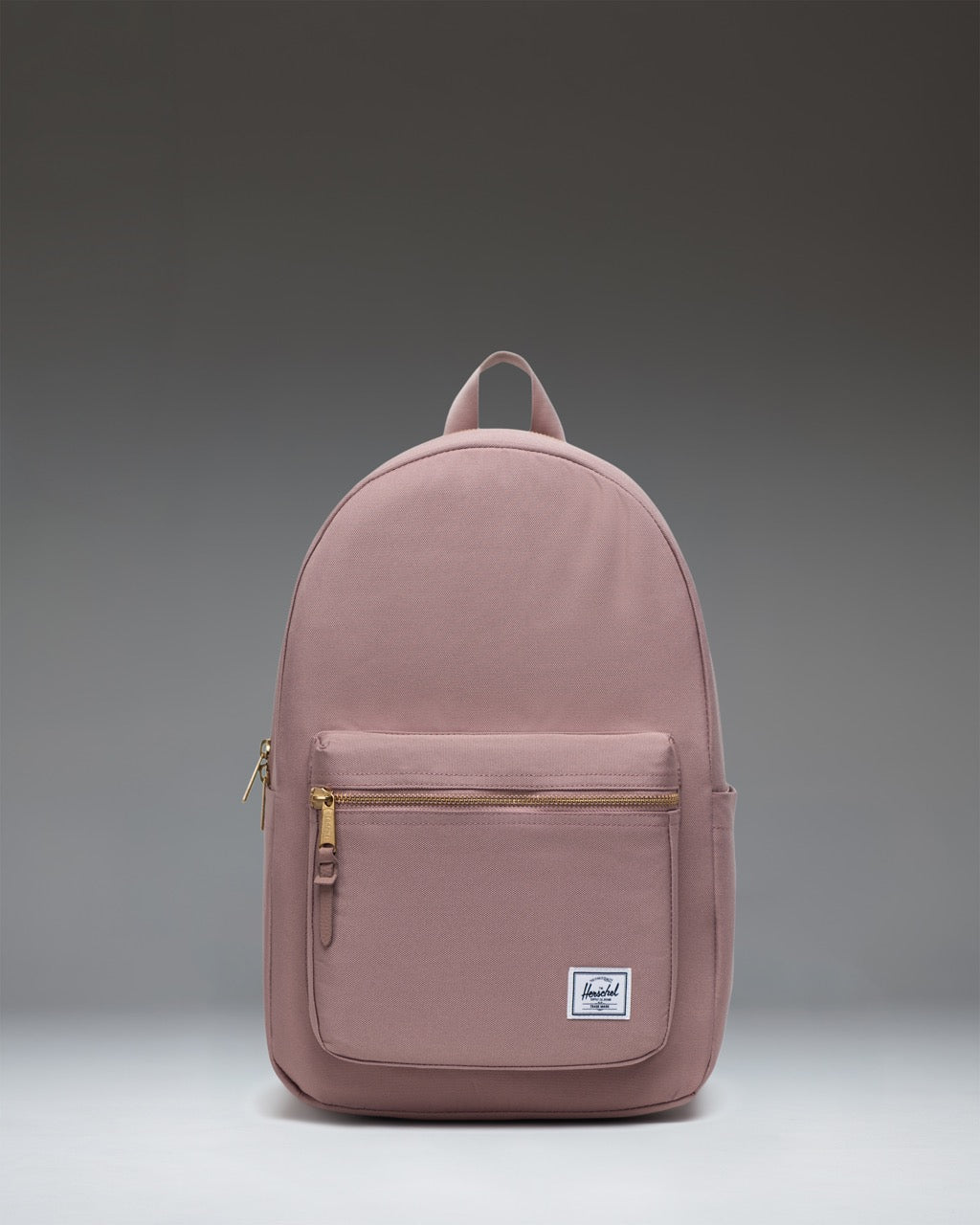 Herschel Supply Co. Settlement Backpack in Ash Rose, featuring a classic design with a zippered front pocket and woven label.
