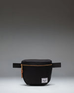 Herschel Supply Co. Settlement Hip Pack in black shown from the front, highlighting its clean design and classic woven label.
