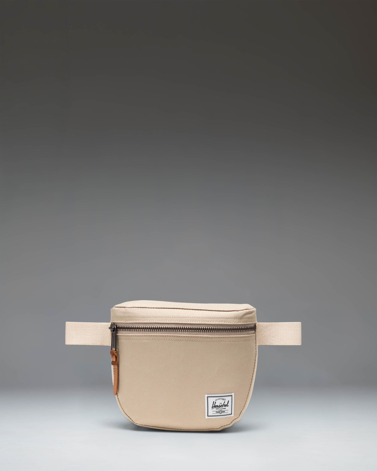 Herschel Supply Co. Settlement Hip Pack in Eucalyptus green shown from the front, featuring a zipper closure and a woven brand label.