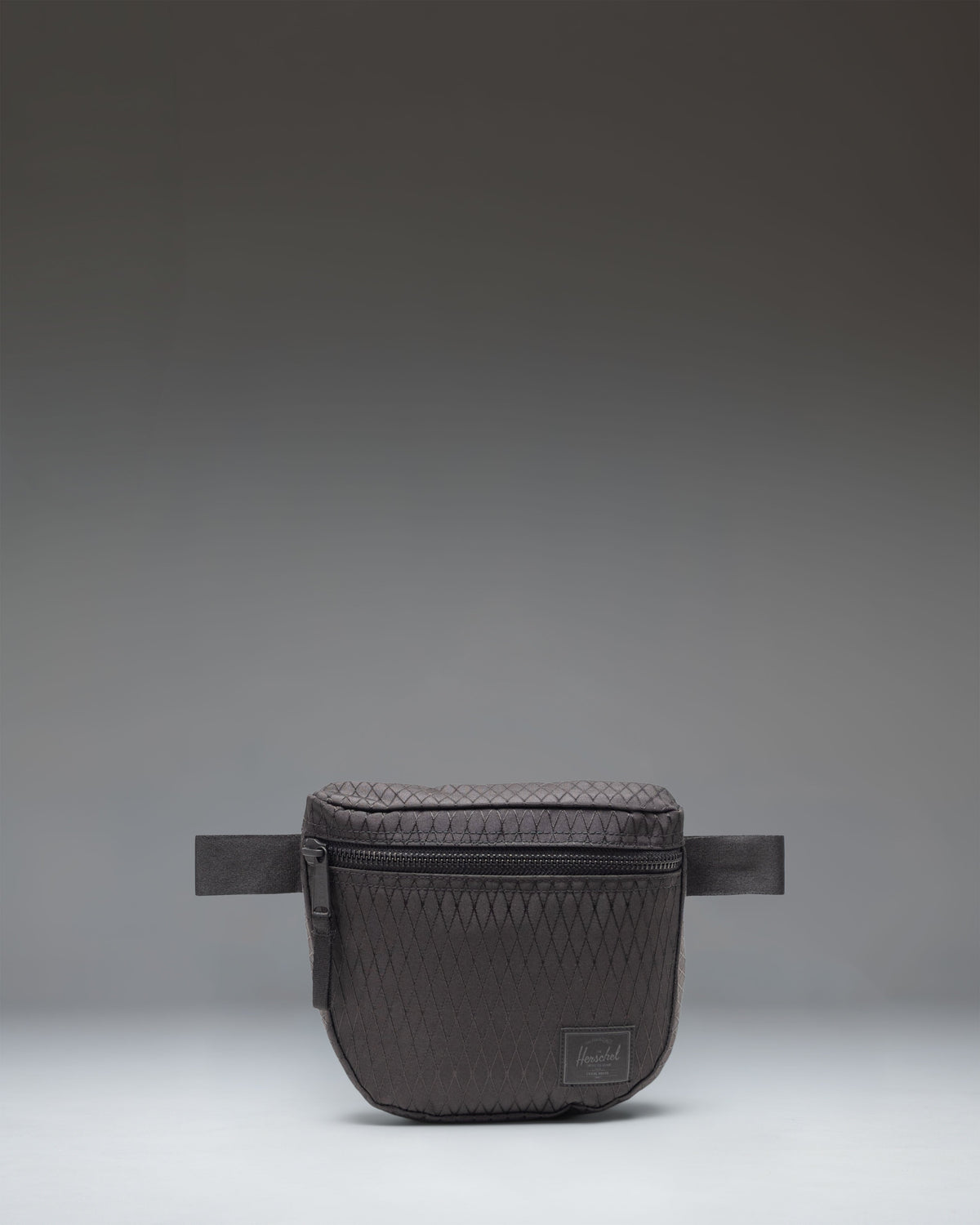 Herschel Supply Co. Settlement Hip Pack in Black Diamond/Black, showing the front view of the compact waist bag with zipper closure.