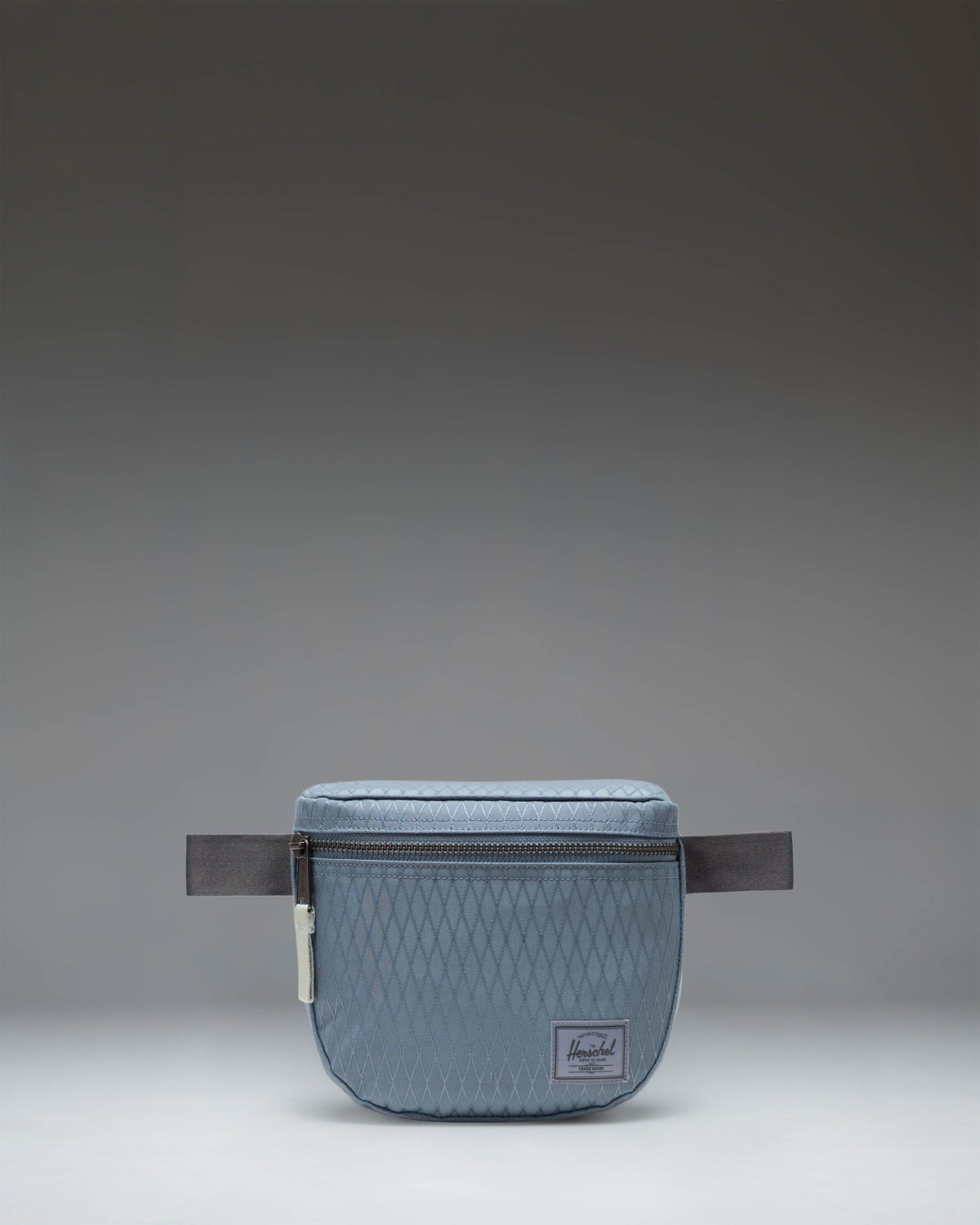 Herschel Supply Co. Settlement Hip Pack in Blue Mirage Diamond and Sea Storm blue patterns.