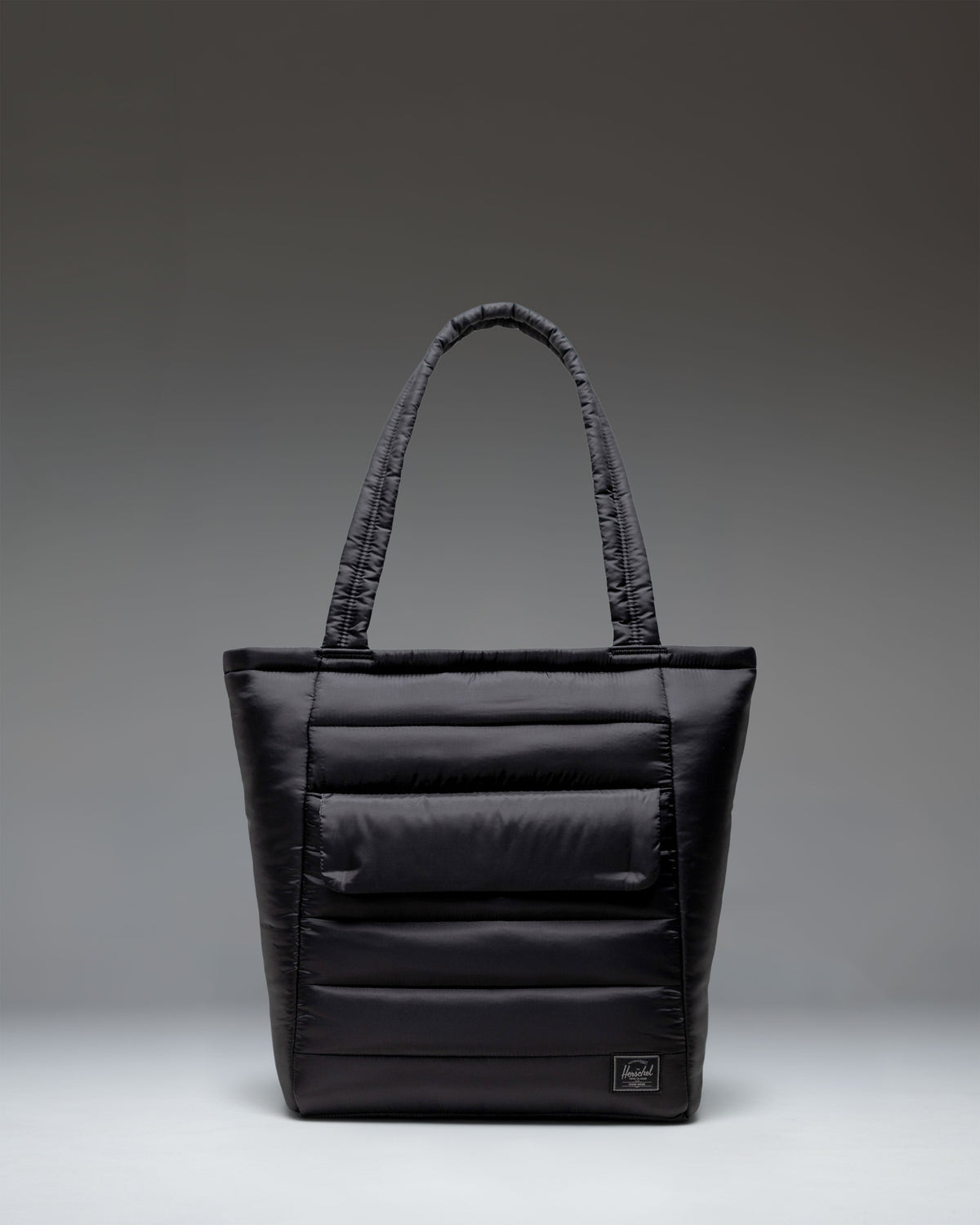 Black Herschel Retreat Tote bag shown from the front against a white background.