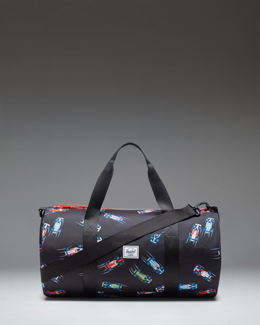 Herschel Classic Duffle Little Herschel in Race Cars print, featuring a pattern of colorful race cars on a dark background.