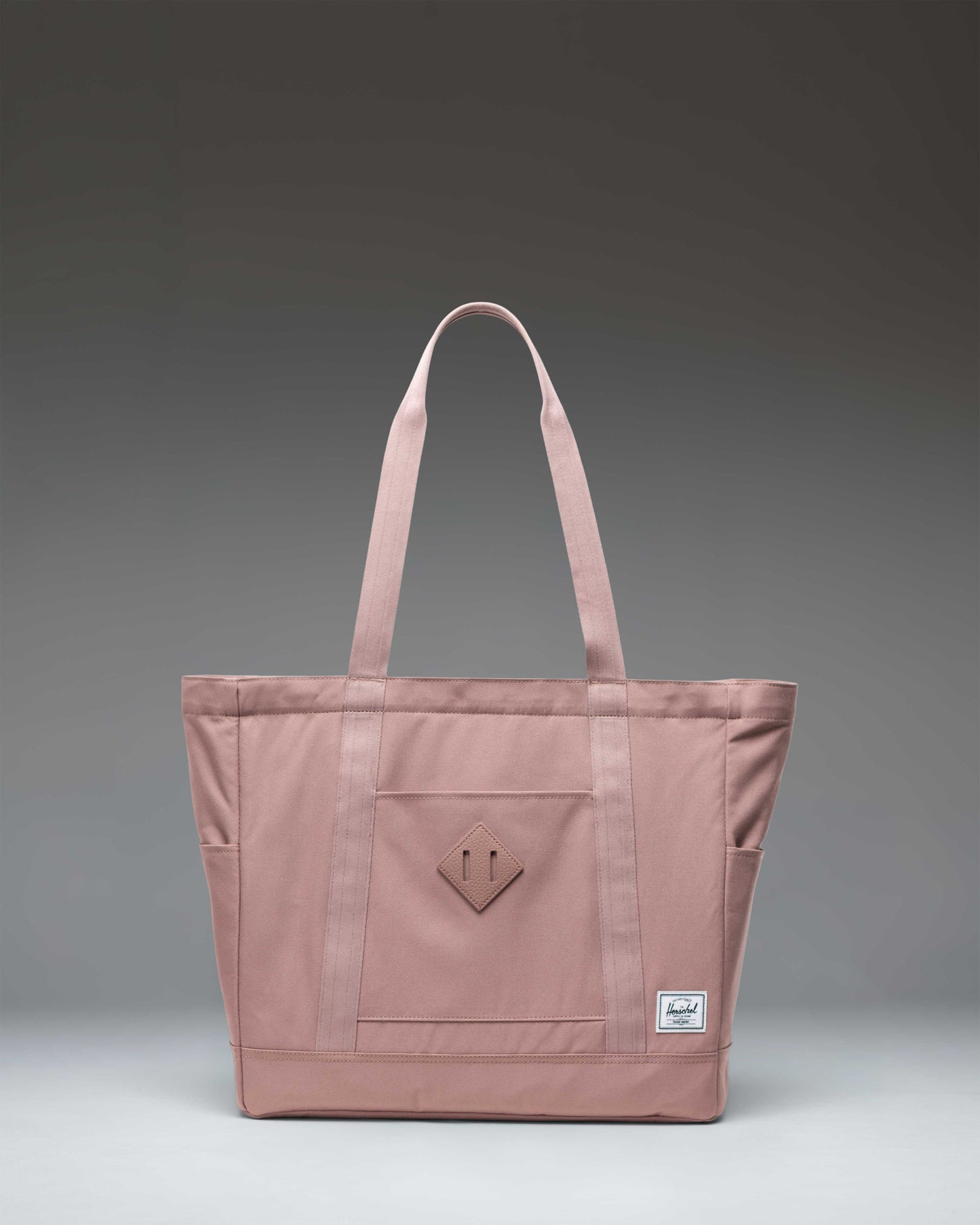 Herschel Heritage Tote bag in Ash Rose pink color, featuring a classic design with dual carrying handles and a reinforced base.