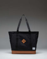Herschel Heritage Tote bag in Black with Saddle Brown straps and base detailing, shown from the front against a plain background.