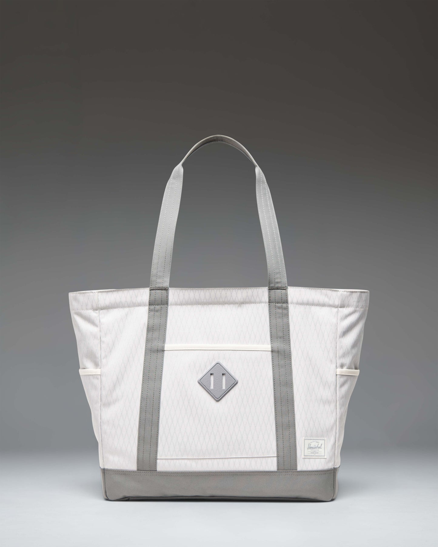 Herschel Heritage Tote in Vapor Diamond/Charcoal Gray, showing the front view of the canvas tote bag with signature diamond detail.