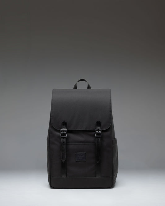 Herschel Supply Co. Retreat Small Backpack in Black showing the front view with signature strap closures.