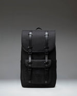 Black Herschel Little America Backpack featuring a classic mountaineering design with magnetic strap closures and a front pocket.