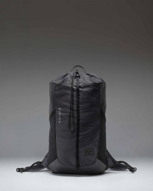 Black Herschel Supply Co Ultralight Cinch Daypack 14 L backpack shown from the front with a drawstring closure and a front zippered pocket.