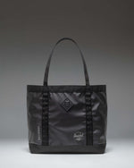 Herschel Supply Co. All Season Gear Tote 33 L in black, showing a lifestyle view of the durable everyday bag.