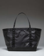 Herschel Supply Co. All Season Gear Tote 63L in black, shown from the front highlighting its large capacity and durable handles.