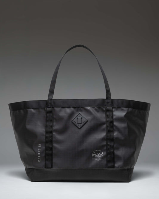 Herschel Supply Co. All Season Gear Tote 63L in black, shown from the front highlighting its large capacity and durable handles.