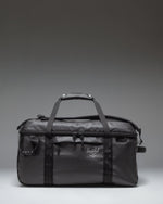 Herschel Supply Co. All Season Duffle bag 41 L in black, showing the clean front view with handles and adjustable shoulder strap.