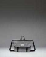 Herschel Supply Co. Cove Small Messenger bag in Raven Crosshatch grey, showing a front view with a flap closure, handle, and adjustable shoulder strap.