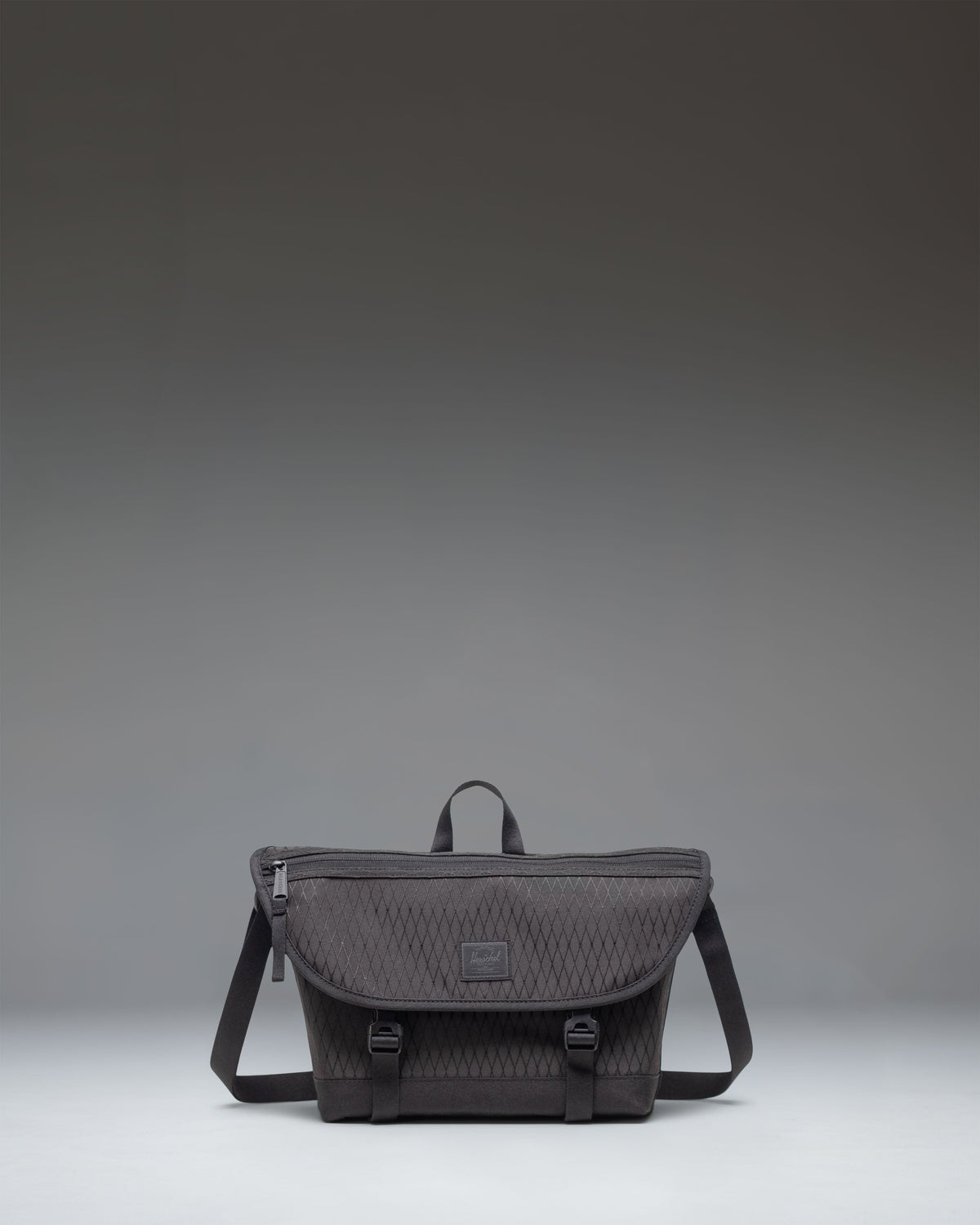 Black Herschel Cove Small Messenger bag shown from the front against a white background.