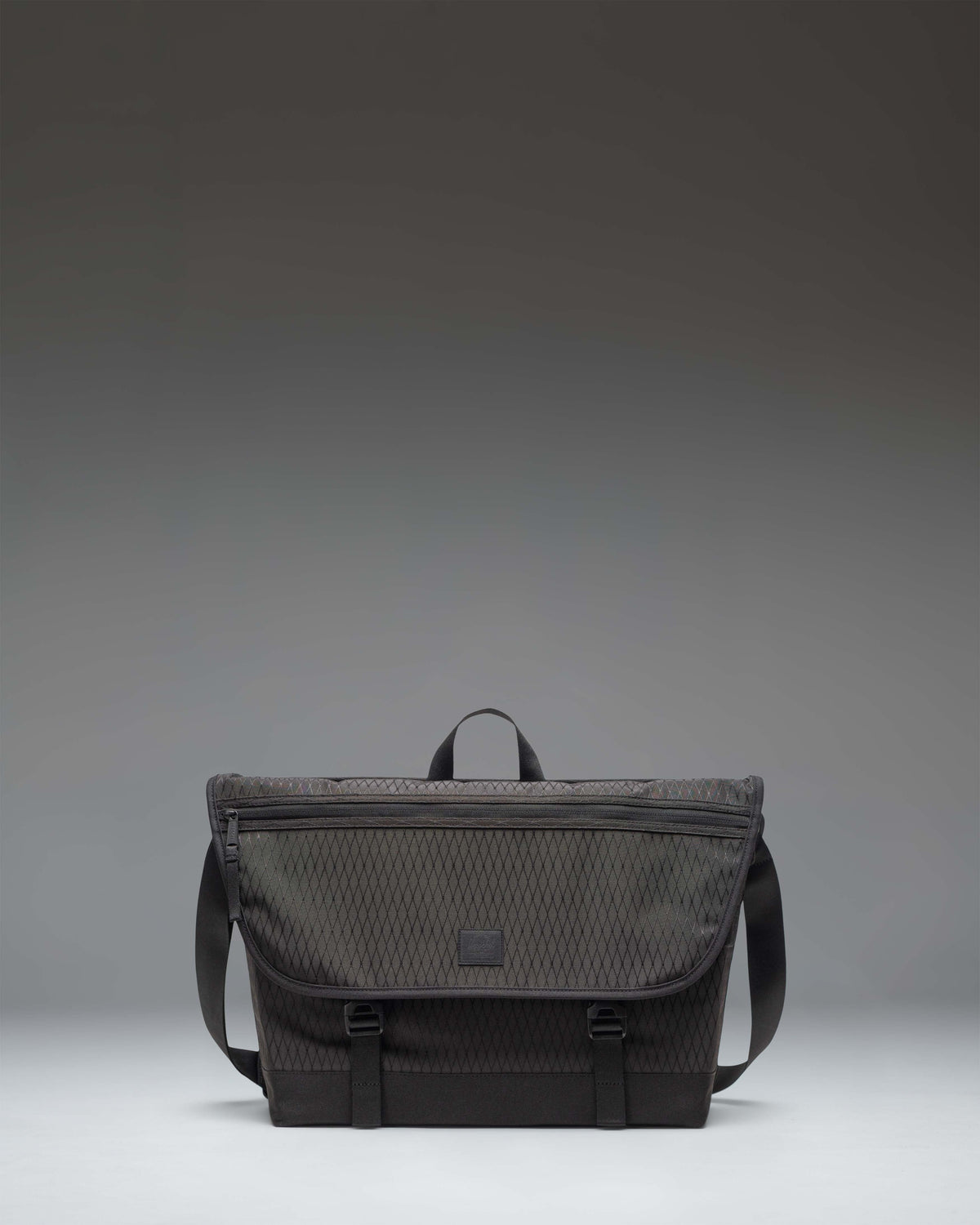 Herschel Supply Co. Cove Messenger bag in Black Diamond/Black, showing the clean, durable front design and adjustable shoulder strap.