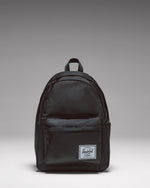 Black Herschel Classic Backpack with a zippered front pocket and the classic woven logo label on the front.