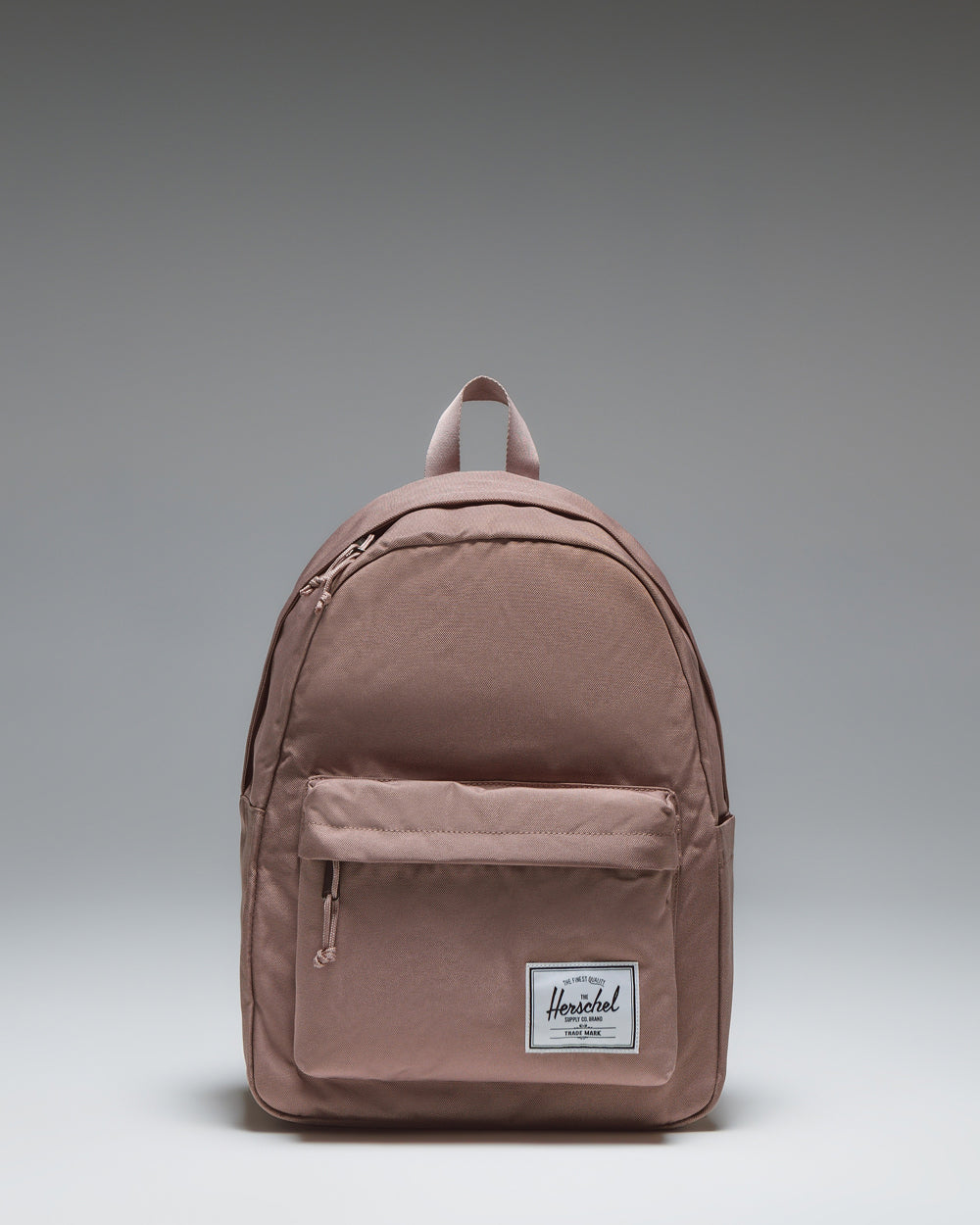Herschel Classic Backpack in Ash Rose, front view showing the main compartment and front pocket.