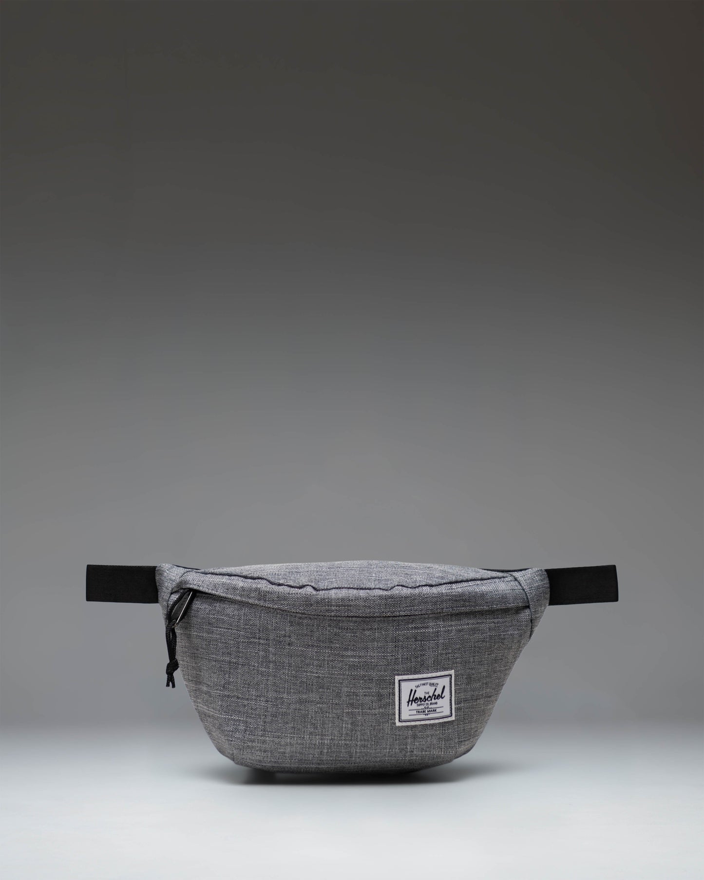 Herschel Classic Hip Pack in Raven Crosshatch grey. Front view showing main zipper compartment, adjustable strap, and classic woven label.