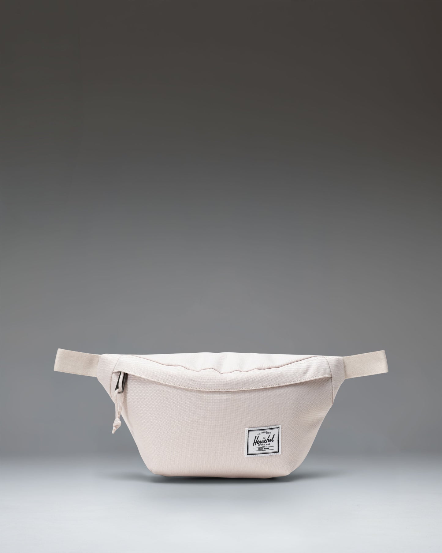 Herschel Classic Hip Pack in Moonbeam beige colorway, showing the clean front design with a zippered main compartment and adjustable strap.