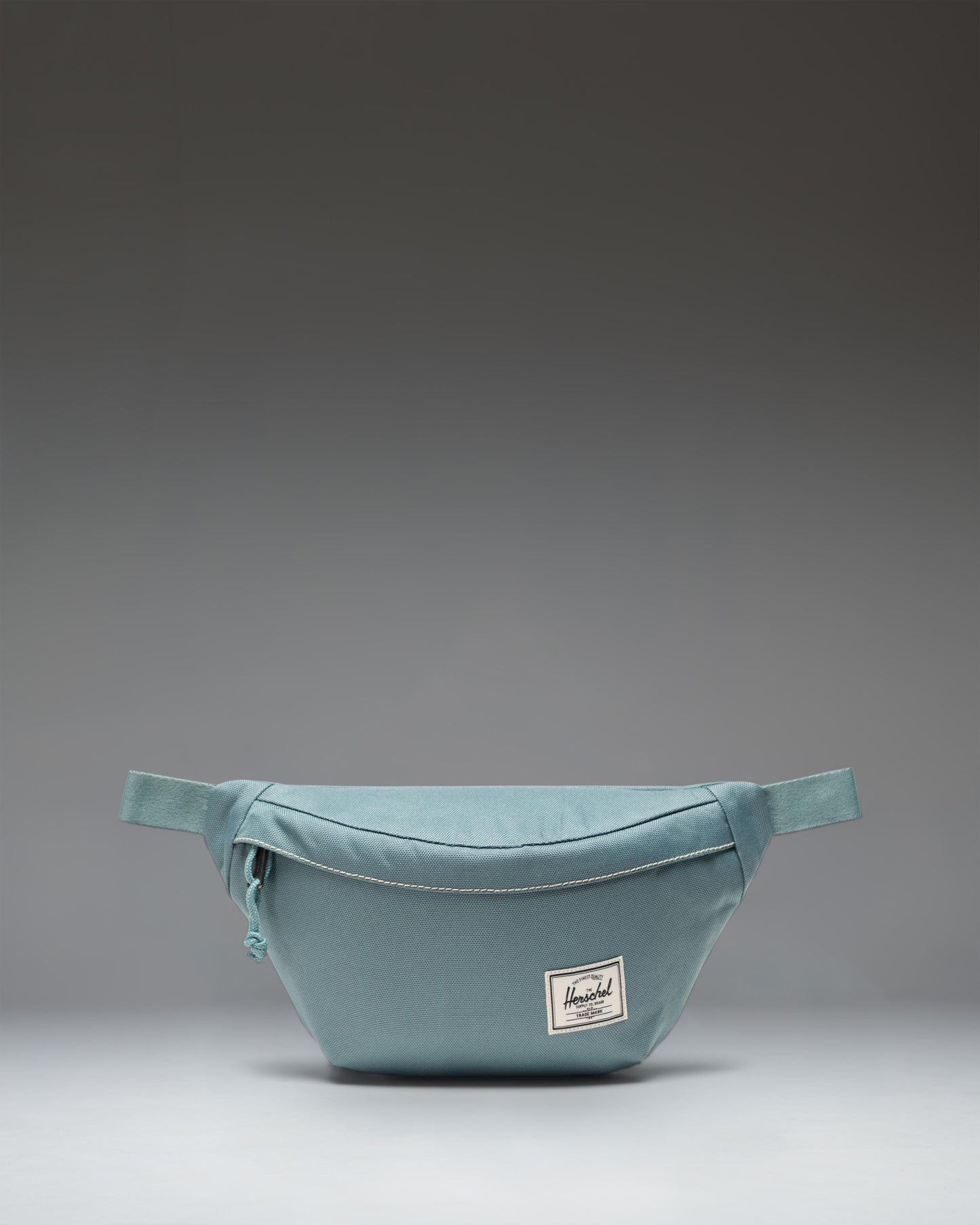 Herschel Classic Hip Pack, a compact 1L waist pack featuring a zippered main closure with a Prusik cord pull and an adjustable webbing strap.