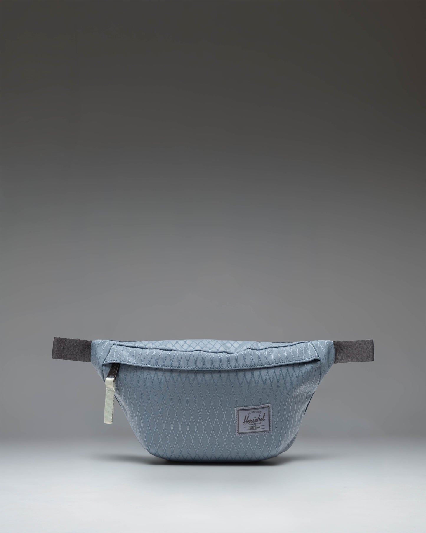 Herschel Classic Hip Pack in Blue Mirage Diamond and Sea Storm colorway, showing the front view with zipper closure and adjustable strap.