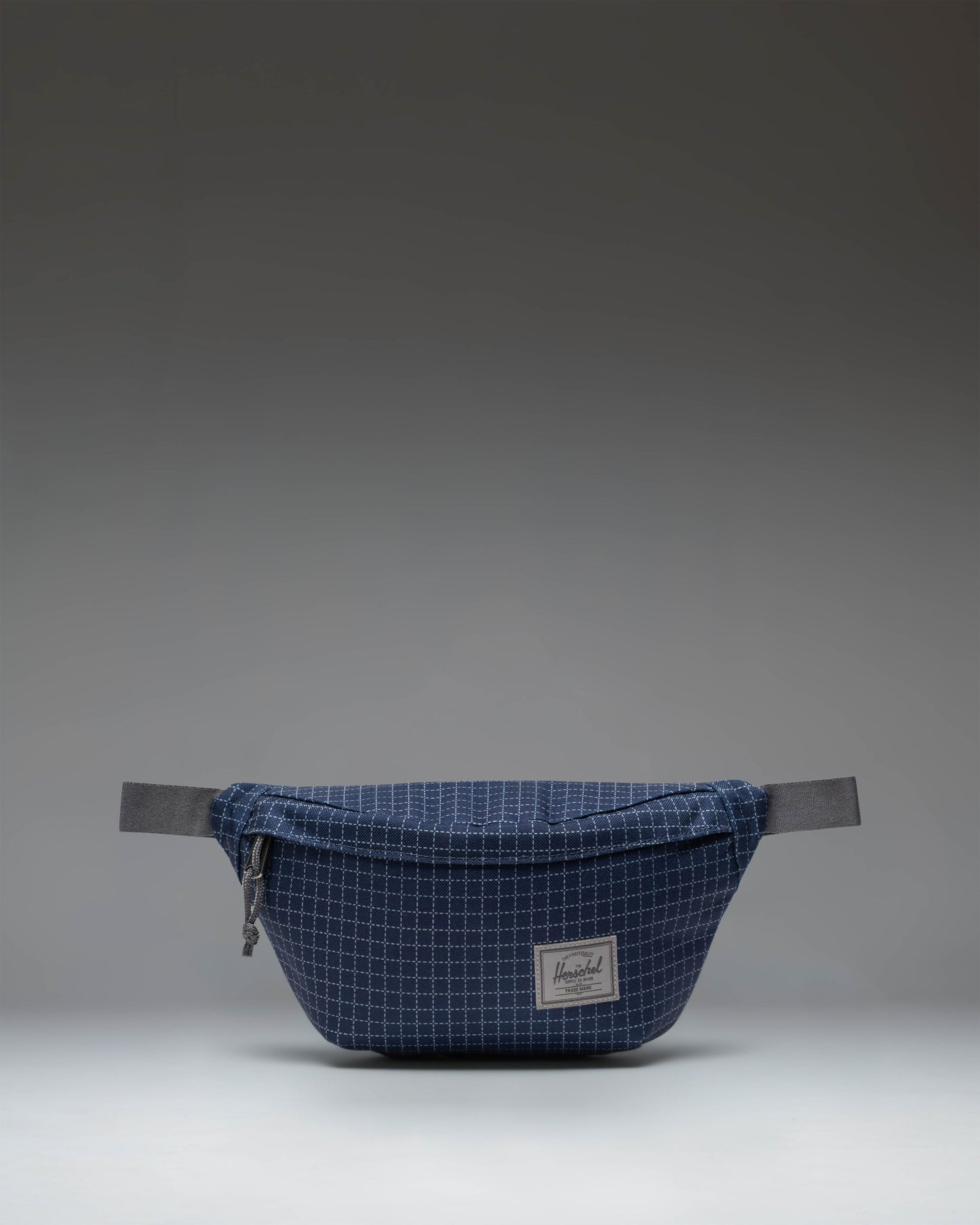 Herschel Classic Hip Pack in Grid Naval Academy/Magnet colorway, showcasing its compact, multi-pocket design.