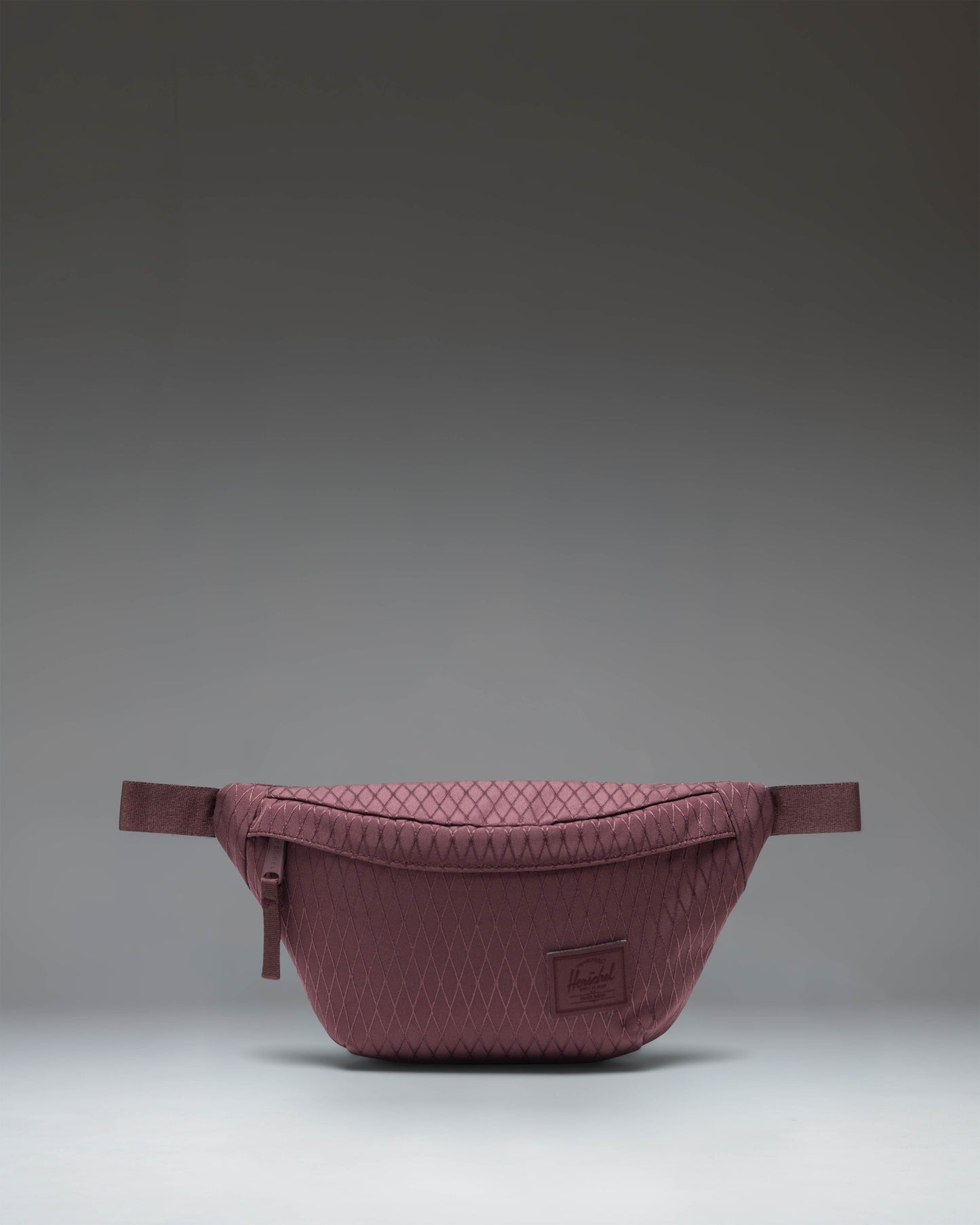 Herschel Supply Co. Herschel Classic Hip Pack in Huckleberry Diamond, a purple waist bag with a front pocket and adjustable strap.