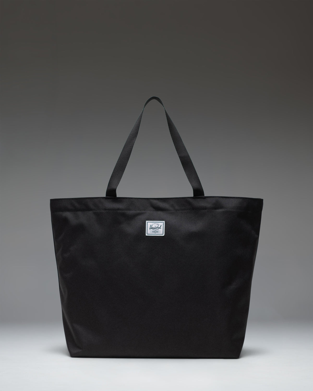 Herschel Classic Tote in Black, featuring a clean, minimalist design with dual top carrying handles.