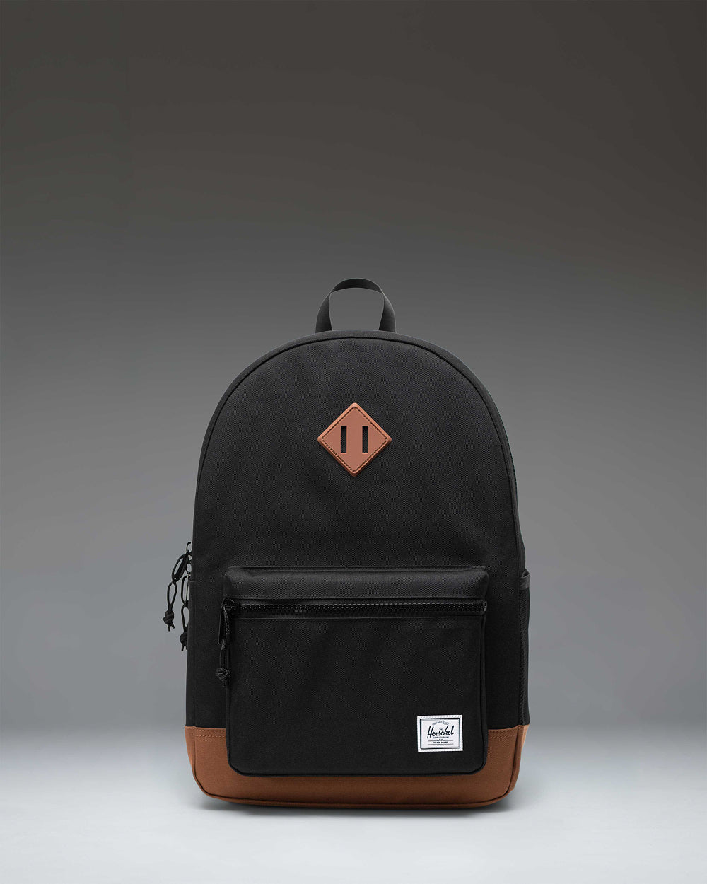 Herschel Heritage Youth Backpack in Black with Saddle Brown rubber strap detail.