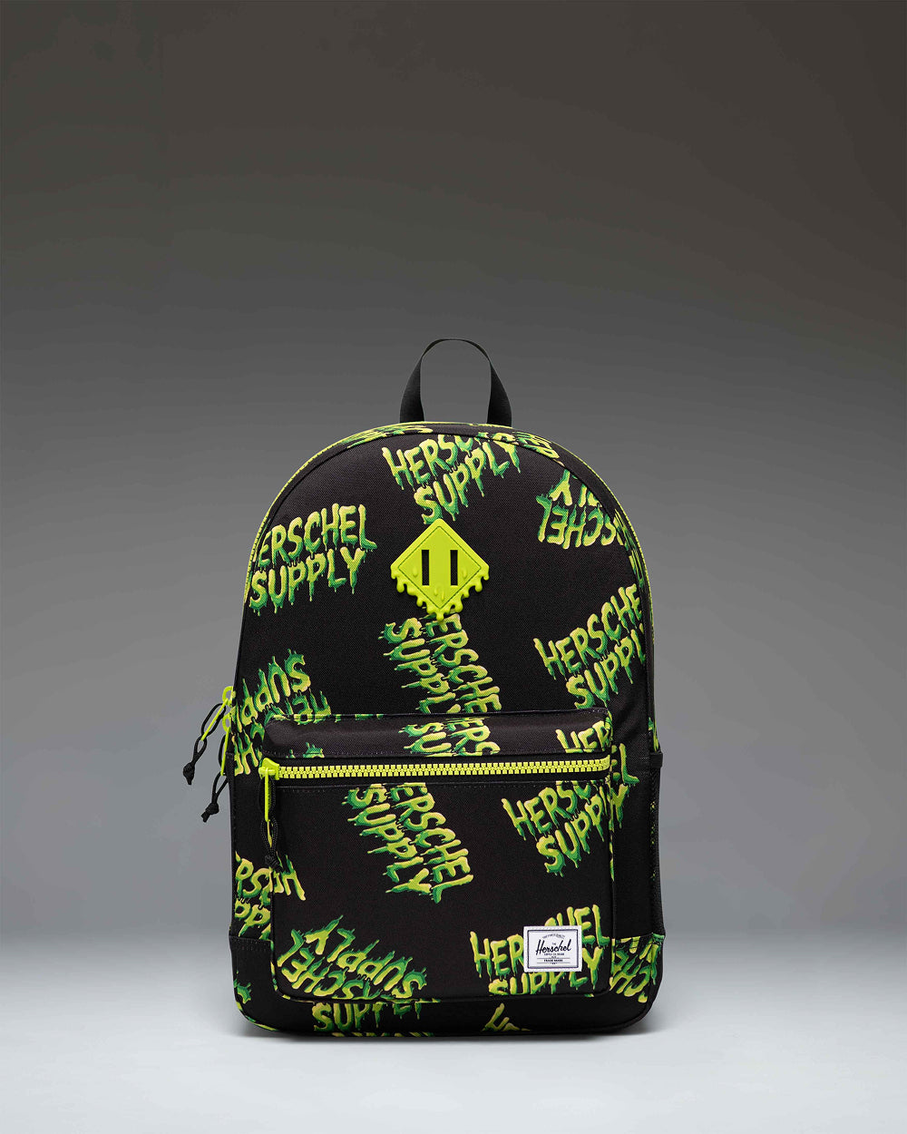 Herschel Heritage Youth Backpack in HSC Slime green featuring a classic diamond accent, zippered front pocket, and mesh water bottle pocket.