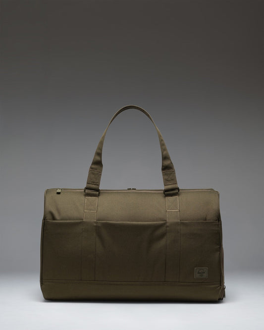 Herschel Novel Duffle Tech bag in Ivy Green Tonal featuring carrying handles and a removable shoulder strap.