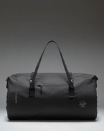 Herschel Supply Co. Dry Bag Duffle 55L in black, showcasing its durable waterproof material and roll-top closure design.