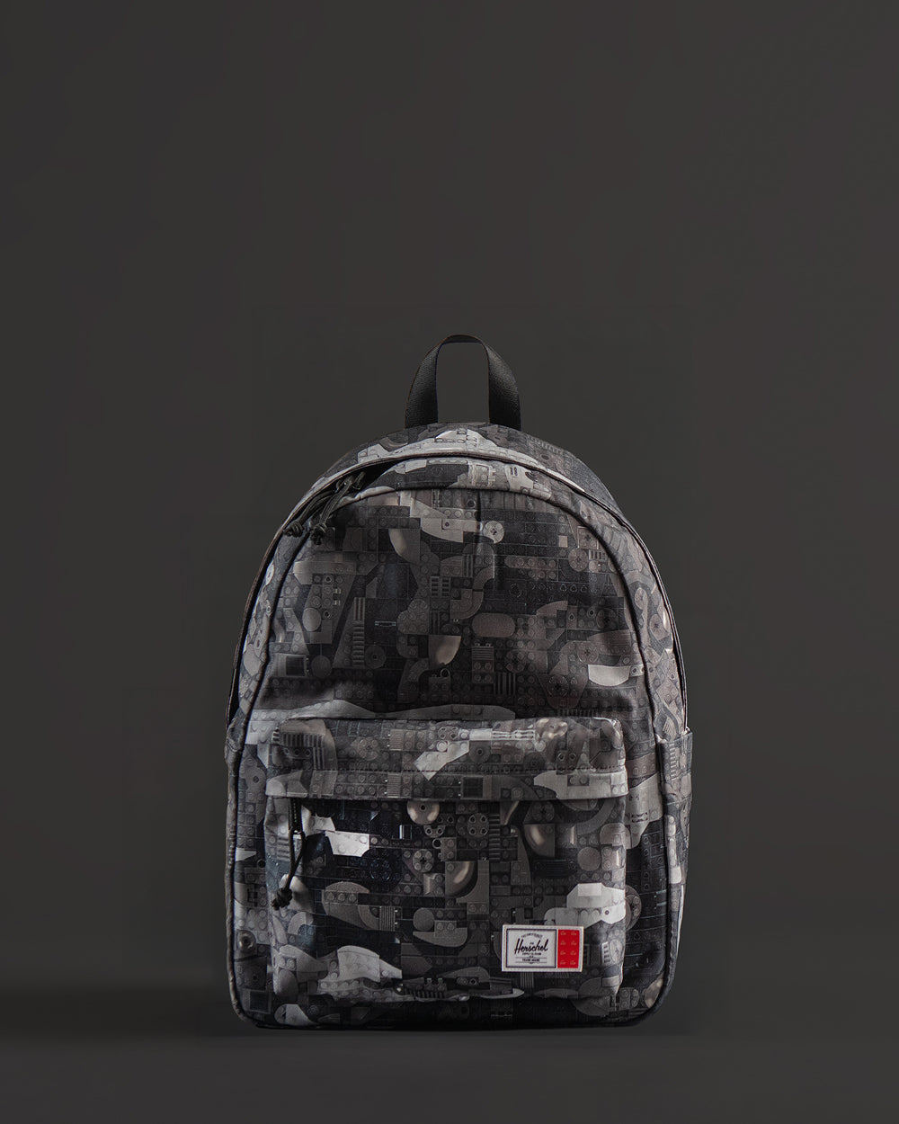 Herschel Supply Co. LEGO Classic Backpack in Abstract Bricks Black featuring a black body with a subtle tonal geometric brick pattern.