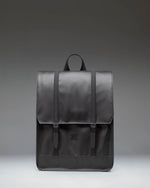 Herschel Survey Backpack in black, showing the front view with its classic square silhouette and dual strap closures.