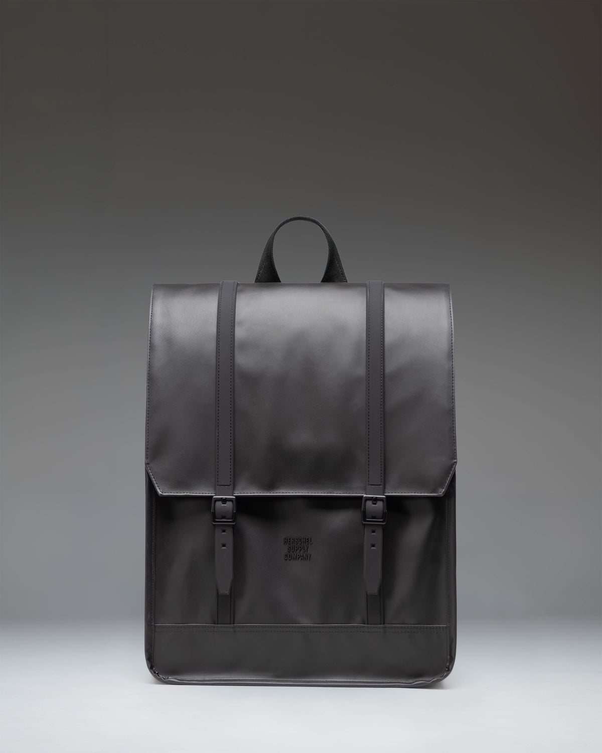 Herschel Survey Backpack in black, showing the front view with its classic square silhouette and dual strap closures.